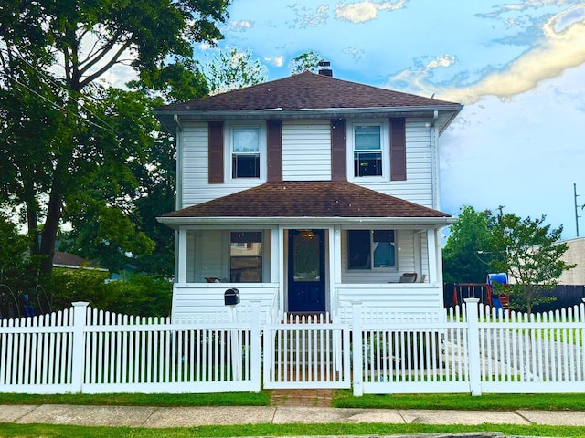 90 Redmond Ave, Bay Shore, NY 11706 - traditional style home with a porch, a chimney, roof with shingles, and a fenced front yard