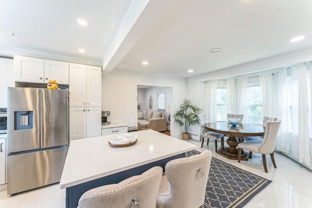 90 Redmond Ave, Bay Shore, NY 11706 - kitchen with stainless steel appliances, light stone counters, white cabinets, a center island, and recessed lighting