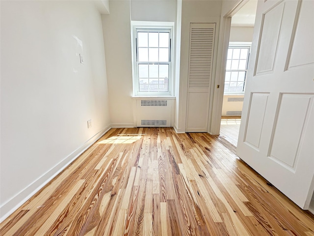35-24 78th St Unit A67, Jackson Heights, NY 11372 - unfurnished bedroom featuring radiator heating unit and light wood-style flooring