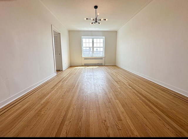 35-24 78th St Unit A67, Jackson Heights, NY 11372 - spare room with a chandelier, light wood-style flooring, and crown molding