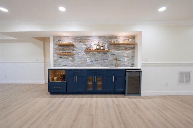 37 William St, Bohemia, NY 11716 - indoor wet bar with beverage cooler, light wood-type flooring, decorative backsplash, crown molding, and recessed lighting
