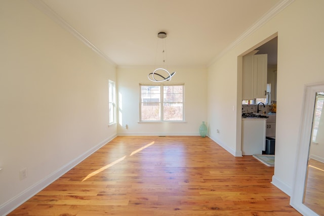 37 William St, Bohemia, NY 11716 - unfurnished dining area featuring ornamental molding, light wood-style floors, and healthy amount of natural light