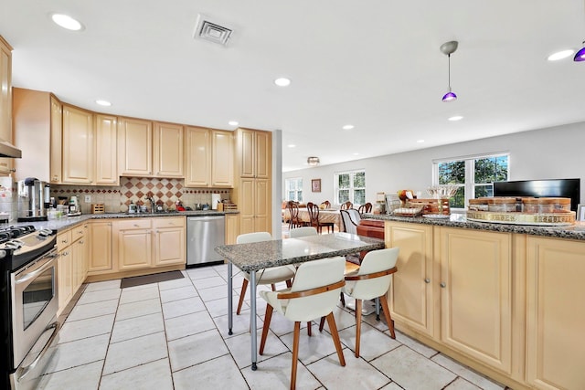 97 Burnham Ave, Roslyn Heights, NY 11577 - kitchen with appliances with stainless steel finishes, backsplash, recessed lighting, a breakfast bar area, and light tile patterned floors