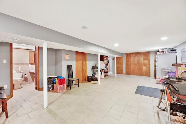 97 Burnham Ave, Roslyn Heights, NY 11577 - finished below grade area featuring freestanding refrigerator, recessed lighting, and light tile patterned floors