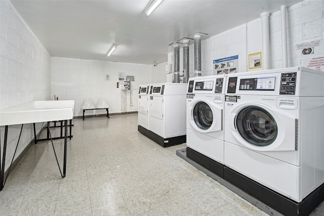 115 Dehaven Dr Unit 214, Yonkers, NY 10703 - shared laundry room featuring washing machine and dryer, concrete block wall, and tile patterned floors