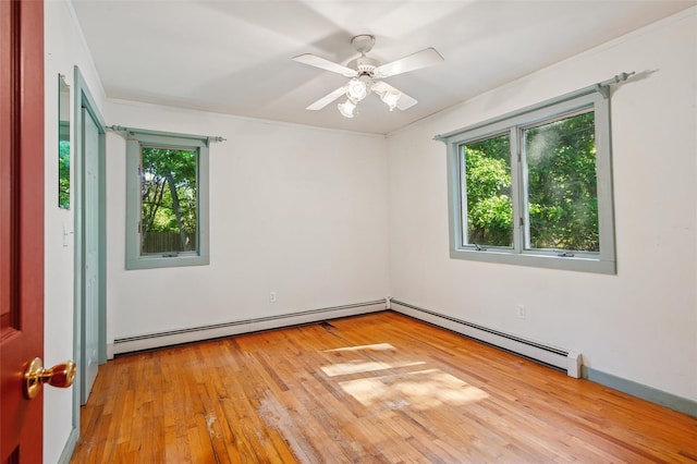 27 Jagger Ln, Westhampton, NY 11977 - spare room featuring a baseboard heating unit, light wood finished floors, and a ceiling fan