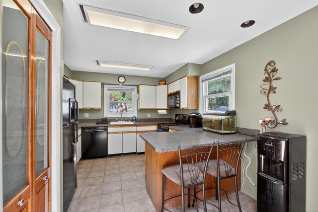 3324 Sycamore Ln, Yorktown Heights, NY 10598 - kitchen featuring black appliances, a peninsula, plenty of natural light, and white cabinetry