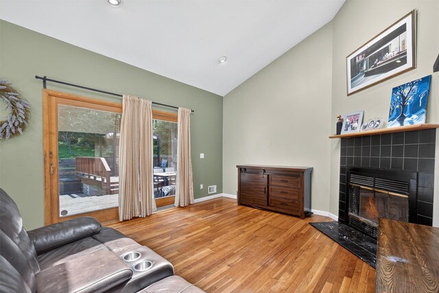 3324 Sycamore Ln, Yorktown Heights, NY 10598 - living room with wood finished floors, a tiled fireplace, high vaulted ceiling, and recessed lighting