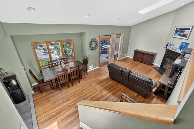 3324 Sycamore Ln, Yorktown Heights, NY 10598 - living area featuring wood finished floors, vaulted ceiling, a fireplace with flush hearth, recessed lighting, and a skylight
