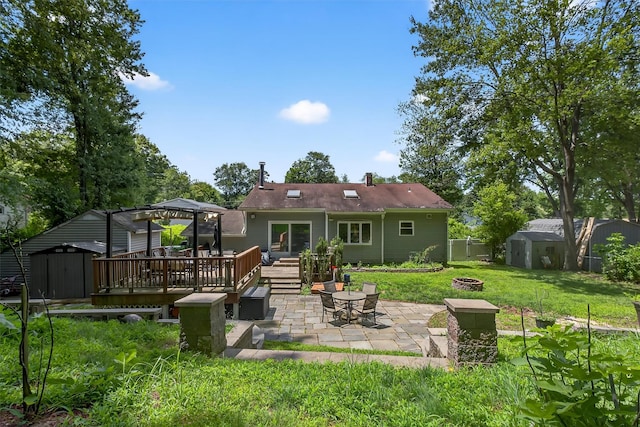 3324 Sycamore Ln, Yorktown Heights, NY 10598 - rear view of property with a storage shed, a fire pit, a patio, and a deck