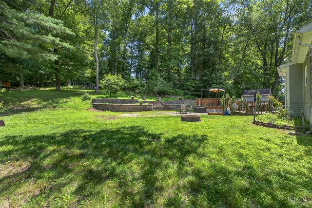 3324 Sycamore Ln, Yorktown Heights, NY 10598 - view of grassy yard featuring a fire pit and a deck