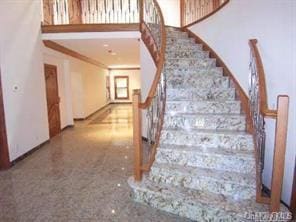 52 Snapdragon Ln, Roslyn Heights, NY 11577 - staircase with a towering ceiling and crown molding