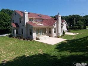 52 Snapdragon Ln, Roslyn Heights, NY 11577 - back of house featuring a chimney, a patio area, a yard, and a balcony