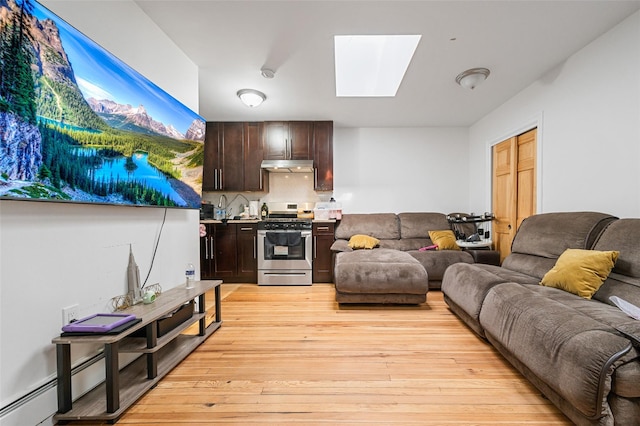 74-25 93rd Ave, Woodhaven, NY 11421 - living area with a skylight and light wood-style flooring