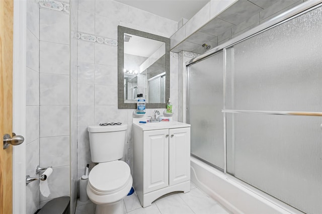 74-25 93rd Ave, Woodhaven, NY 11421 - bathroom with combined bath / shower with glass door, vanity, and tile walls