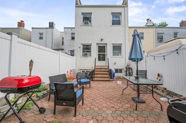 74-25 93rd Ave, Woodhaven, NY 11421 - rear view of property featuring entry steps, stucco siding, a patio area, and a fenced backyard