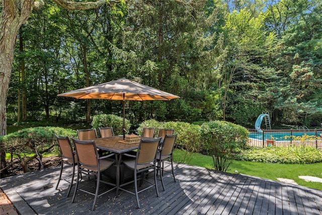 26 Rolling Dr, Brookville, NY 11545 - wooden deck with outdoor dining space and a view of trees