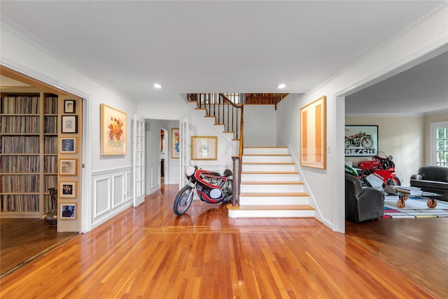 26 Rolling Dr, Brookville, NY 11545 - stairs with wood finished floors, recessed lighting, crown molding, and a decorative wall