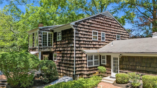 26 Rolling Dr, Brookville, NY 11545 - view of side of home featuring a chimney