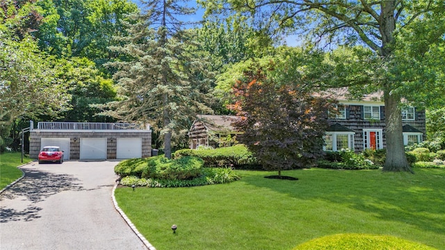 26 Rolling Dr, Brookville, NY 11545 - view of front of house with a front yard and asphalt driveway