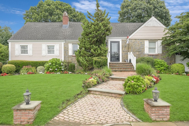 3309 Balsam St, Oceanside, NY 11572 - view of front of house featuring stone siding, a chimney, and a front lawn