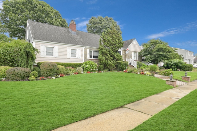 3309 Balsam St, Oceanside, NY 11572 - view of front of home with a chimney, a front lawn, and a shingled roof