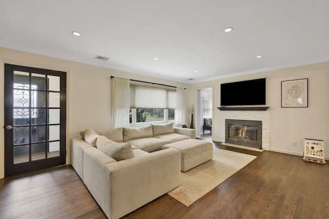 3309 Balsam St, Oceanside, NY 11572 - living room featuring a fireplace, ornamental molding, dark wood finished floors, and recessed lighting