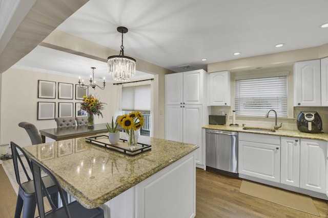 3309 Balsam St, Oceanside, NY 11572 - kitchen with dishwasher, a breakfast bar area, a chandelier, a center island, and white cabinetry