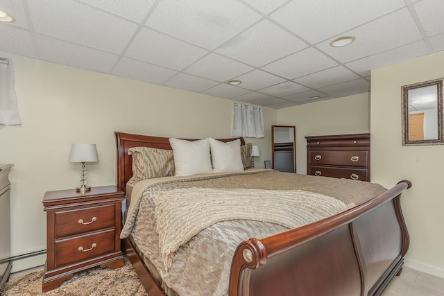 3309 Balsam St, Oceanside, NY 11572 - tiled bedroom featuring a paneled ceiling, baseboard heating, and recessed lighting