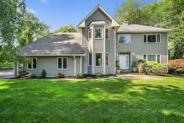 70 Hickory St, Blauvelt, NY 10913 - view of front of home featuring a chimney, a front yard, roof with shingles, and a patio