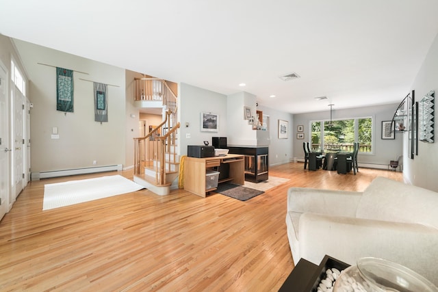 70 Hickory St, Blauvelt, NY 10913 - living area with baseboard heating, light wood finished floors, stairs, recessed lighting, and a baseboard heating unit