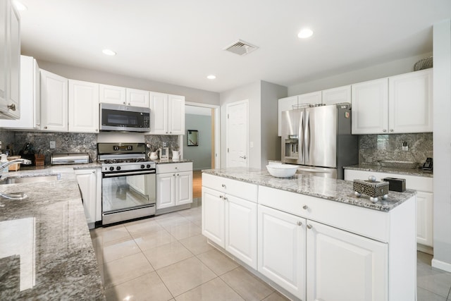 70 Hickory St, Blauvelt, NY 10913 - kitchen with appliances with stainless steel finishes, backsplash, white cabinetry, recessed lighting, and light tile patterned flooring