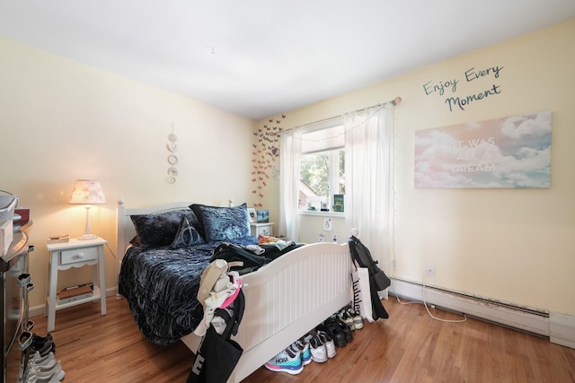 70 Hickory St, Blauvelt, NY 10913 - bedroom featuring a baseboard heating unit and wood finished floors