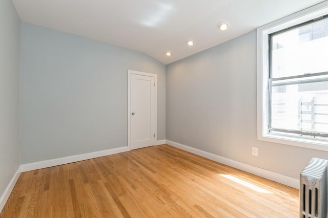 1110 Caton Ave Unit 5C, Brooklyn, NY 11218 - unfurnished room with radiator heating unit, light wood-type flooring, recessed lighting, and lofted ceiling