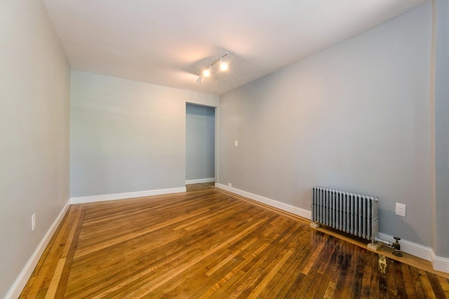 1110 Caton Ave Unit 5C, Brooklyn, NY 11218 - empty room featuring radiator, hardwood / wood-style flooring, and rail lighting