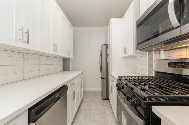 1110 Caton Ave Unit 5C, Brooklyn, NY 11218 - kitchen with appliances with stainless steel finishes, backsplash, and white cabinetry