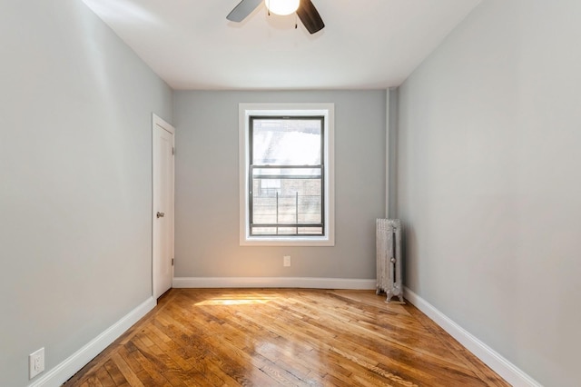 1110 Caton Ave Unit 5C, Brooklyn, NY 11218 - spare room with radiator heating unit, light wood-style floors, and ceiling fan