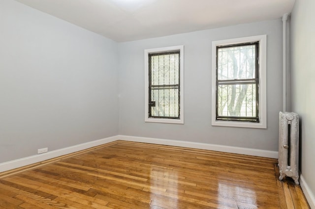 1110 Caton Ave Unit 5C, Brooklyn, NY 11218 - spare room featuring radiator heating unit and hardwood / wood-style floors