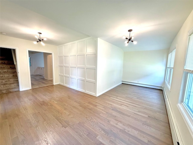 55 Red Mill Rd, Cortlandt Manor, NY 10567 - empty room featuring a chandelier, light wood-type flooring, and healthy amount of natural light