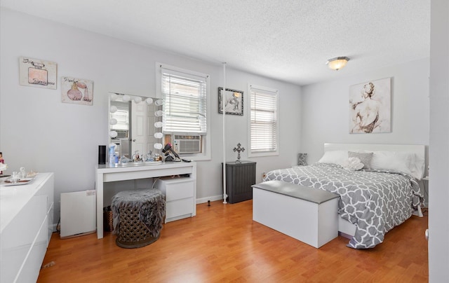 96-36 149th Ave, Ozone Park, NY 11417 - bedroom featuring light wood-style floors, a textured ceiling, and cooling unit