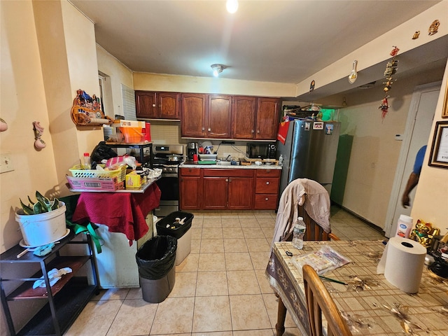 1053 Evergreen Ave, Bronx, NY 10472 - kitchen featuring stainless steel appliances, light countertops, and light tile patterned flooring