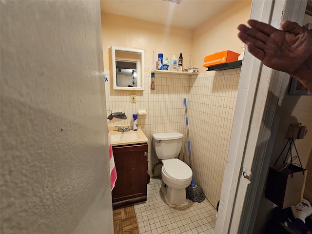 1053 Evergreen Ave, Bronx, NY 10472 - bathroom with vanity, tile walls, and wainscoting