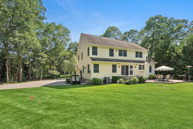1 Alexis, Speonk, NY 11972 - rear view of house with a lawn, a patio area, and driveway