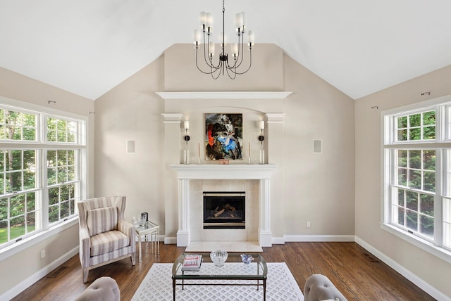 1 Alexis, Speonk, NY 11972 - living room featuring lofted ceiling, a chandelier, a fireplace, healthy amount of natural light, and wood finished floors