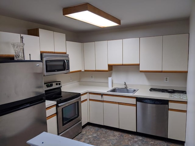 972 Skyline Dr Unit 972, Coram, NY 11727 - kitchen featuring appliances with stainless steel finishes, light countertops, and white cabinets