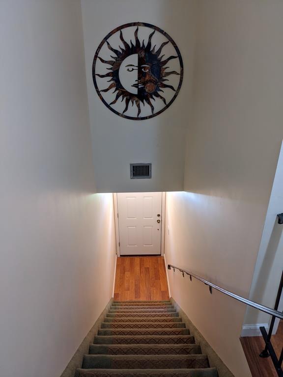 972 Skyline Dr Unit 972, Coram, NY 11727 - stairs featuring wood finished floors