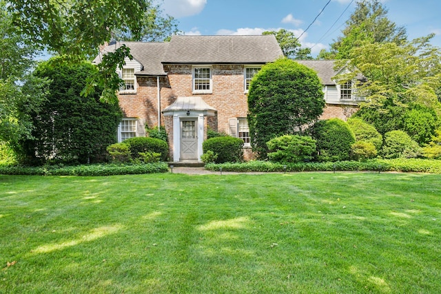 21 Orchard Dr, East Williston, NY 11596 - view of front of home with a front lawn and brick siding