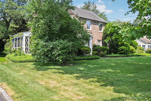 21 Orchard Dr, East Williston, NY 11596 - view of property exterior with a lawn, brick siding, and a sunroom