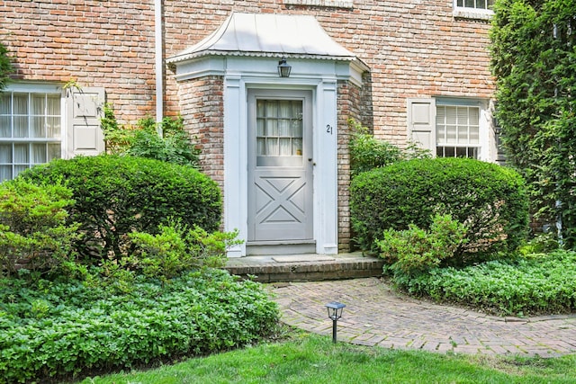 21 Orchard Dr, East Williston, NY 11596 - doorway to property with brick siding