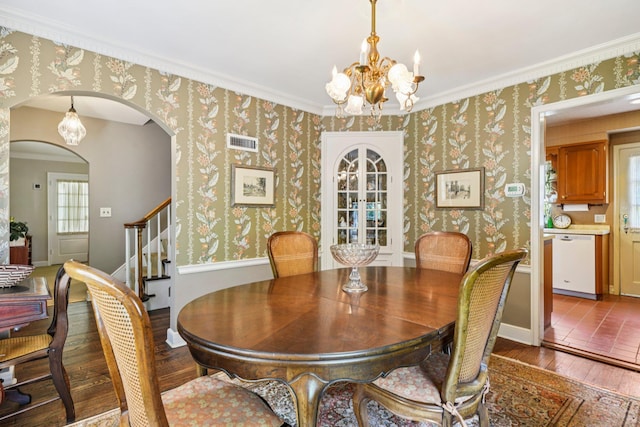 21 Orchard Dr, East Williston, NY 11596 - dining space with hardwood / wood-style floors, arched walkways, a chandelier, plenty of natural light, and crown molding